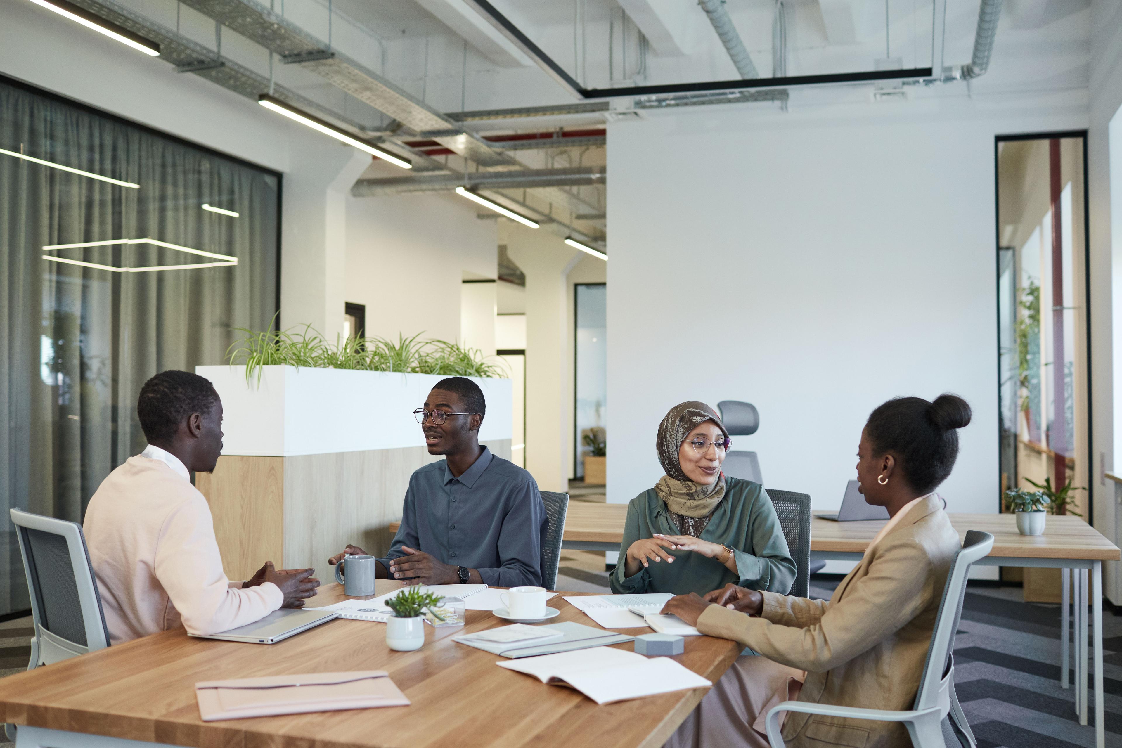 Professionals discussing work around a table